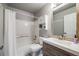 Bright bathroom featuring a shower over tub, a vanity and medicine cabinet for storage at 5559 S Quemoy Cir, Aurora, CO 80015