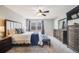 Spacious primary bedroom featuring plush carpet, neutral colors, a ceiling fan, dresser and blue accents at 5559 S Quemoy Cir, Aurora, CO 80015