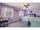 Charming bedroom with a ceiling fan, carpet and bright natural light from the windows at 5559 S Quemoy Cir, Aurora, CO 80015