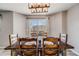 Inviting dining area featuring a wooden table, comfortable chairs, and serene ambiance at 5559 S Quemoy Cir, Aurora, CO 80015