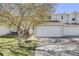 Charming townhome with a two-car garage, beautiful tree, and well-maintained lawn at 5559 S Quemoy Cir, Aurora, CO 80015