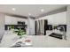 Modern kitchen features stainless steel appliances, white cabinets, and a beautiful quartz countertop with a stylish sink at 5559 S Quemoy Cir, Aurora, CO 80015