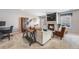 Comfortable living room featuring a fireplace, large windows, and a stylish workspace at 5559 S Quemoy Cir, Aurora, CO 80015