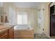 Bright bathroom with soaking tub, separate glass shower, and natural light from the window at 1386 Avgare Way, Erie, CO 80516