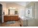 Bright bathroom with double sinks, soaking tub, separate glass shower, and natural light at 1386 Avgare Way, Erie, CO 80516