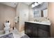Bathroom featuring modern fixtures, a granite countertop, and a convenient layout at 1386 Avgare Way, Erie, CO 80516