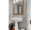 Powder room with pedestal sink, framed mirror, and gray walls at 1386 Avgare Way, Erie, CO 80516