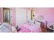 Bright bedroom with pink walls and closet with sliding doors at 1386 Avgare Way, Erie, CO 80516