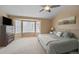 Spacious bedroom features a large bed, bay window, ceiling fan and comfortable carpeting at 1386 Avgare Way, Erie, CO 80516