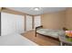 Cozy bedroom featuring carpet, white closet doors and a twin bed at 1386 Avgare Way, Erie, CO 80516