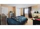 Cozy bedroom with dark bedding, storage shelves, and closet at 1386 Avgare Way, Erie, CO 80516
