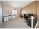 Bedroom featuring neutral colors, an office desk, and a window for natural light at 1386 Avgare Way, Erie, CO 80516