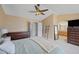 Large primary bedroom featuring a ceiling fan, dual closets, and attached primary bathroom at 1386 Avgare Way, Erie, CO 80516