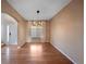 This dining room has beautiful hardwood floors and a modern chandelier at 1386 Avgare Way, Erie, CO 80516
