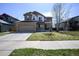 Charming two-story home featuring stone accents, a two-car garage, and a well-maintained front yard at 1386 Avgare Way, Erie, CO 80516