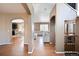 Hallway view showcasing hardwood floors, archways, and open access to the kitchen and living areas at 1386 Avgare Way, Erie, CO 80516