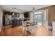 Eat-in kitchen with stainless steel appliances, dark cabinetry, and access to the backyard at 1386 Avgare Way, Erie, CO 80516