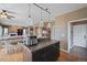 Kitchen island featuring pendant lighting, seating, and an open layout at 1386 Avgare Way, Erie, CO 80516