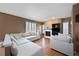 Bright living room with a cozy fireplace, large windows, and hardwood floors at 1386 Avgare Way, Erie, CO 80516