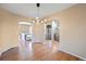 Open-concept living room with hardwood floors and arched doorways at 1386 Avgare Way, Erie, CO 80516