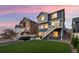 Manicured backyard featuring a lush lawn, hot tub, and deck, great for entertaining and outdoor living at 56 Magnolia Ct, Erie, CO 80516