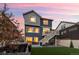 Beautiful two-story home with a spacious backyard, upper deck, and well-manicured lawn at dusk at 56 Magnolia Ct, Erie, CO 80516