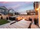 Expansive backyard featuring outdoor seating around a fire pit, dining table, and hot tub, perfect for entertaining at 56 Magnolia Ct, Erie, CO 80516