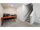 Finished basement with a wet bar, dark cabinetry, mini fridge, wood table, and carpet flooring at 56 Magnolia Ct, Erie, CO 80516