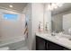 Bright bathroom features a tub with white subway tile and a modern vanity with a marble countertop at 56 Magnolia Ct, Erie, CO 80516