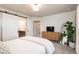 Bright bedroom with a sliding barn door to the bathroom and modern decor at 56 Magnolia Ct, Erie, CO 80516