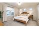 Bright bedroom with a large window, neutral decor, and a comfortable bed at 56 Magnolia Ct, Erie, CO 80516