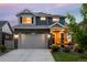 Charming two-story home featuring a stone facade, covered porch, and solar panels, perfect for modern living at 56 Magnolia Ct, Erie, CO 80516