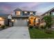 Beautiful two-story house with stone accents, gray siding, and well-maintained lawn, creating a welcoming curb appeal at 56 Magnolia Ct, Erie, CO 80516