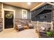 Inviting front porch with comfortable seating and stylish decor, great for relaxing outdoors at 56 Magnolia Ct, Erie, CO 80516