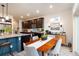 Modern kitchen with dark cabinets, stainless steel appliances, and a dining area at 56 Magnolia Ct, Erie, CO 80516
