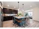 Stylish kitchen with a large island, modern pendant lighting, and dark cabinetry at 56 Magnolia Ct, Erie, CO 80516