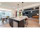 Open concept kitchen featuring stainless steel appliances, granite countertops, and an adjacent dining area at 56 Magnolia Ct, Erie, CO 80516