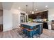 Modern kitchen with a large island, granite countertops, and stainless steel appliances at 56 Magnolia Ct, Erie, CO 80516