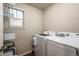 Convenient laundry room with modern appliances and ample storage at 56 Magnolia Ct, Erie, CO 80516