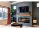 Cozy living room with a fireplace, built-in shelving, and large windows at 56 Magnolia Ct, Erie, CO 80516