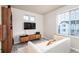 Comfortable living room with ample natural light, modern decor, and a TV at 56 Magnolia Ct, Erie, CO 80516