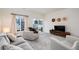 Bright living room with modern decor, comfortable seating, and sliding glass doors to the outdoor space at 56 Magnolia Ct, Erie, CO 80516