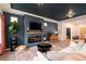 Elegant living room featuring a fireplace, modern decor, and hardwood floors at 56 Magnolia Ct, Erie, CO 80516