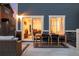 Outdoor patio area with dining table and chairs, accessed via sliding glass doors from the home's interior at 56 Magnolia Ct, Erie, CO 80516