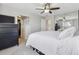 Bright bedroom with mirrored closet doors, a ceiling fan, and a spacious walk-in closet at 5664 S Zang St, Littleton, CO 80127