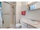 Bathroom with a single sink vanity, a walk-in shower, and white tile at 3161 S Kalispell St, Aurora, CO 80013