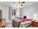 Cozy bedroom featuring plush carpet, a ceiling fan, and a window with views of the outdoors at 3161 S Kalispell St, Aurora, CO 80013