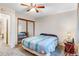 Serene bedroom featuring plush carpet, mirrored closet, and ceiling fan at 3161 S Kalispell St, Aurora, CO 80013