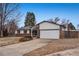 Ranch style home with brick facade, attached garage, and mature landscaping at 3161 S Kalispell St, Aurora, CO 80013