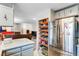 Bright kitchen featuring ample counter space, stainless steel refrigerator, and pantry storage at 3161 S Kalispell St, Aurora, CO 80013